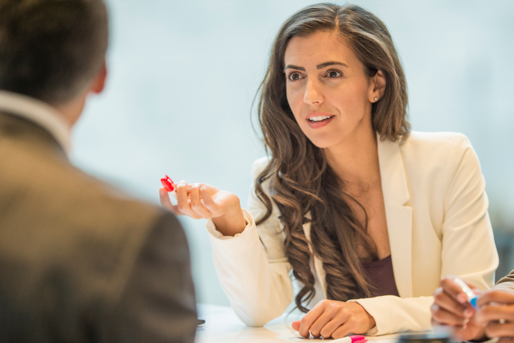 Strong woman talking during a Negotiation with a clear focus and strategy.