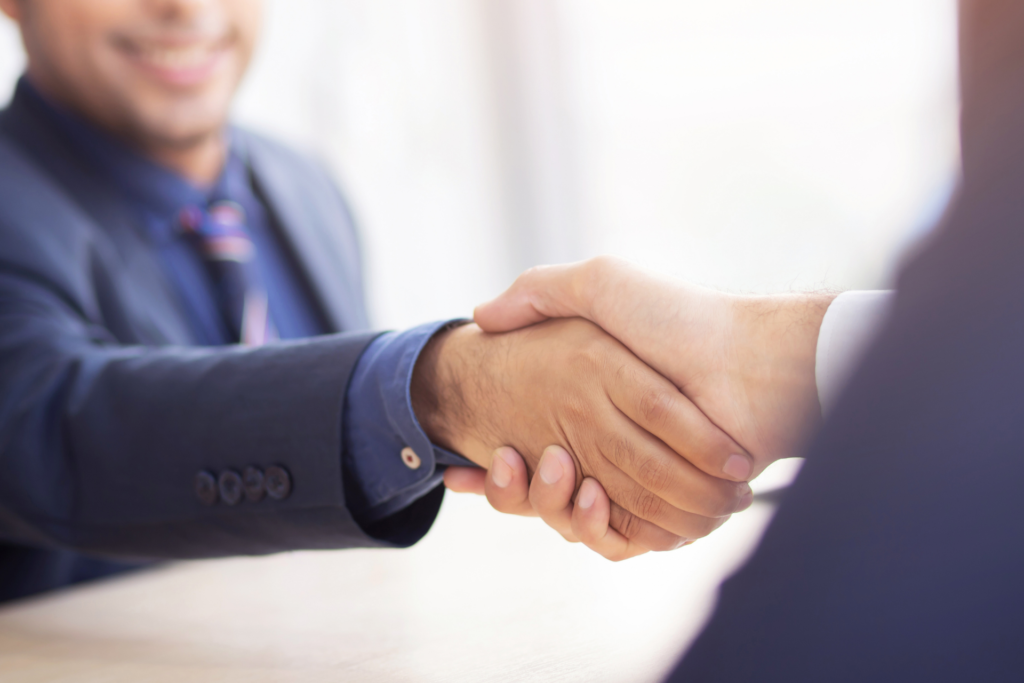 Two people giving a handshake.