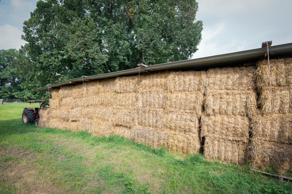 Several straw bales are stacked on top of each other.