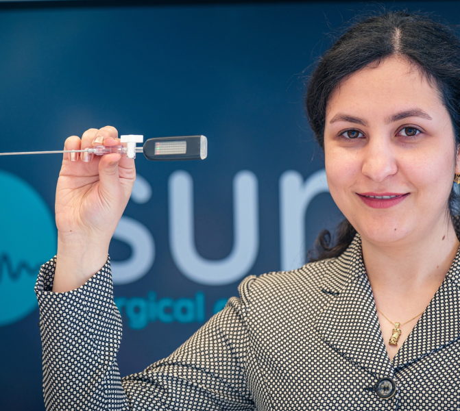 Team member of SURAG holding the SURAG system.